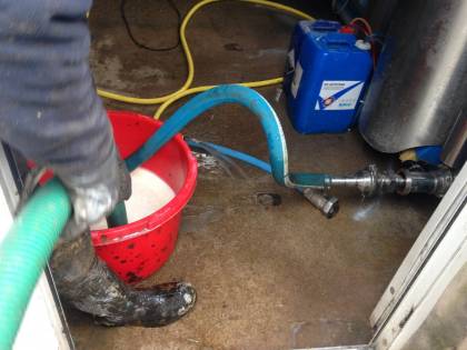 sucking  the milk into slurry tanker